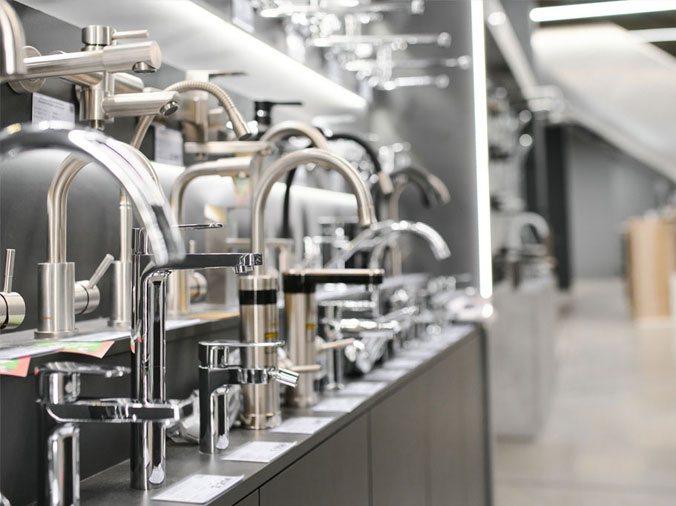 Gooseneck kitchen sink faucets in a plumbing showroom