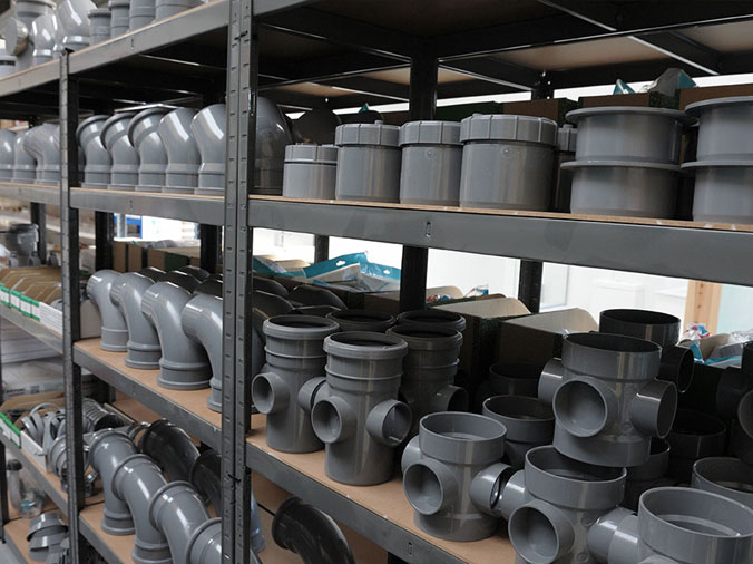 large grey industrial PVC fittings on a shelf