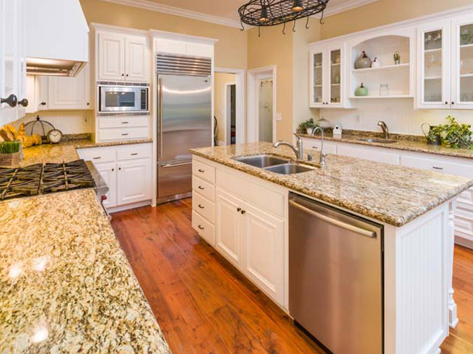 Bright modern kitchen with light colored stone countertops